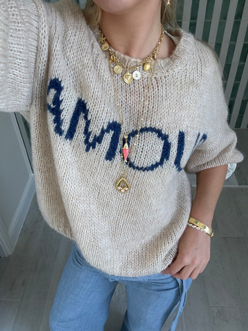 Layered gold necklaces styled for a cool jewellery stack