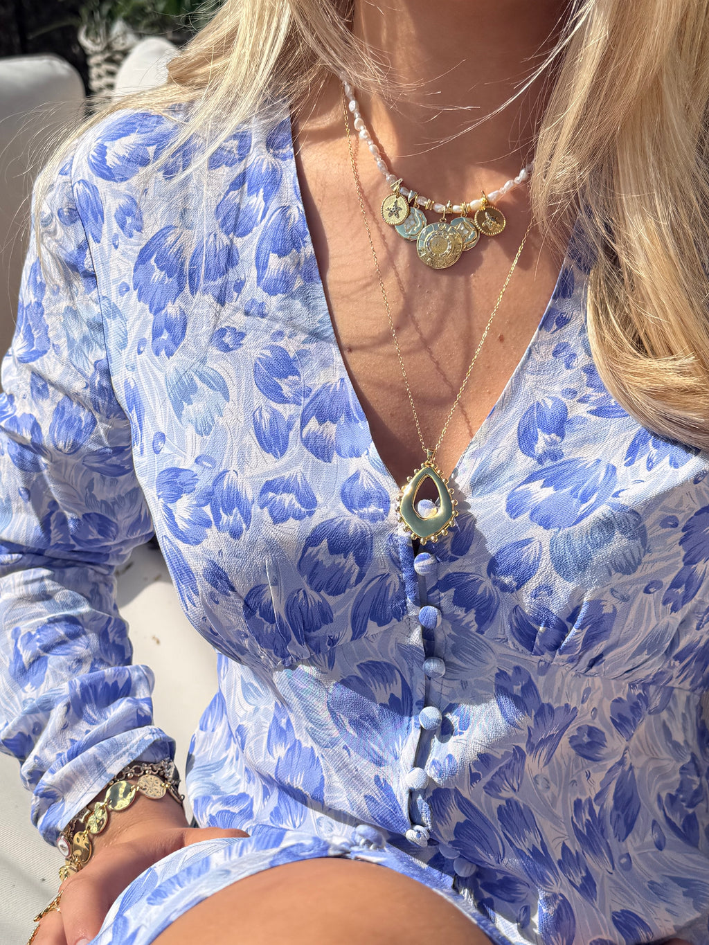 Summer jewellery stack with chunky gold necklaces